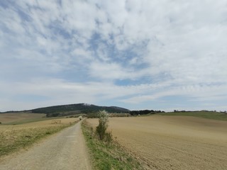 Sunrise and sunset, beautiful clouds over the meadow, hills and buildings in the town. Slovakia