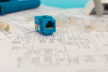 Internet and Network Technology: front view of UTP cable plugs, router modem and over structured cabling network map. Concept of technological services, networks and internet service