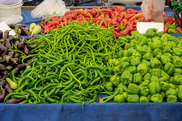 Fresh red and green peppers on the counter of the vegetable market