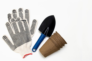 Garden tools: shovel, peat pots. Seeds and home gardening. Growing food at home. mock up of peat pots with blank label. How to grow seedlings at home on a windowsill. Seedling & Home Gardening Tools