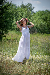 Naklejka na ściany i meble Young woman in white dress