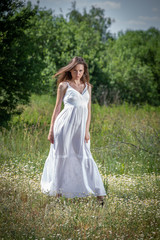 Fototapeta na wymiar Young woman in white dress