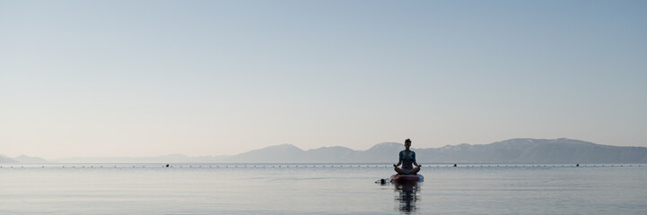 Young woman sitting in lotus position, meditating