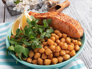 roasted baked salmon fillet with chickpeas, lemon,  and pea sprouts healthy food