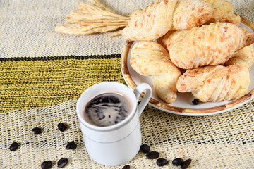 Traditional Brazilian Biscuit with Fresh Cheesebaked cheese biscuit, with cup of coffee, on the table.