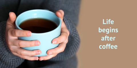 Life begins after coffee. Female hands holding a big cup of coffee, home comfort