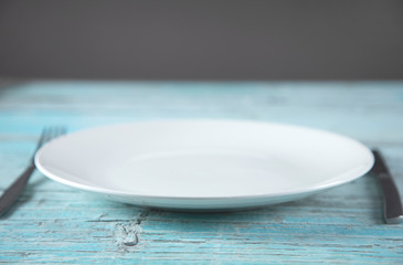 white plate and  knife with  fork