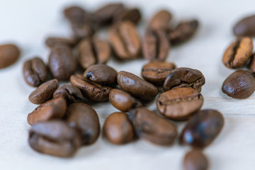 coffee beans isolated on a white background, scattered, close-up