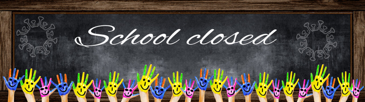 School background banner Panorama - Many brightly painted children's hands in front of a old aged empty blackboard with wooden frame, white lettering "school closed" and space for text