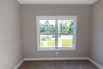 Beige color empty bedroom in a new construction house with a ceiling fan