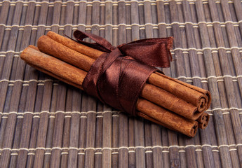 Dried sticks of cinnamon natural spices on bamboo mat