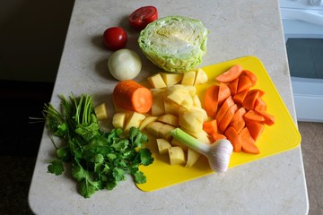 Coarsely chopped vegetables for cooking- tomatoes, onions, potatoes, cabbage, coriander.