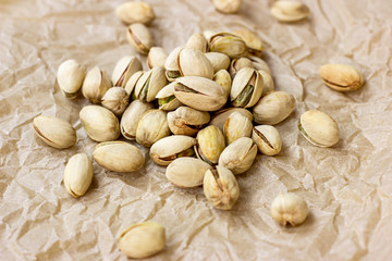 Roasted salted pistachio nuts in nutshell on light background.