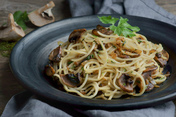 spaghetti with mushrooms on a dark background