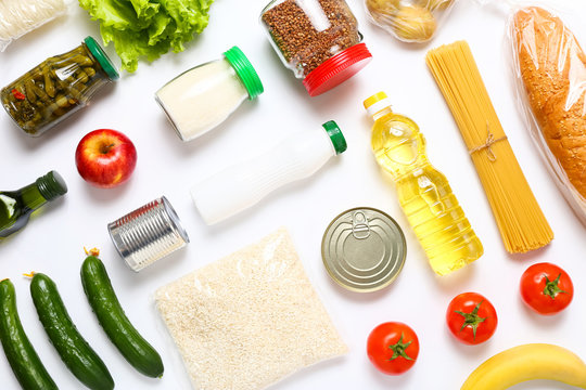 Food supplies for the period of quarantine on white background. Set of grocery items from canned food, vegetables, pasta, cereal. Food delivery concept. Donation concept. Top view.