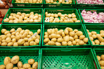 Boxes with fresh potatoes for sale in a supermarket.