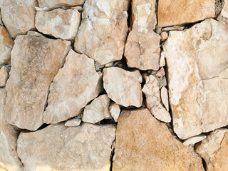 
Stone wall of large yellow stone for background