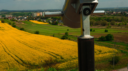 
A telescope with a landscape in the background