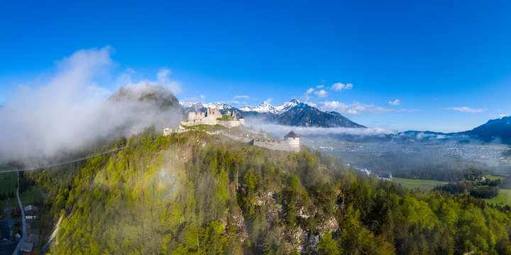 Fototapeta aerial view to ruin eherberg with rope bridge and mountain hahnenkamm in background