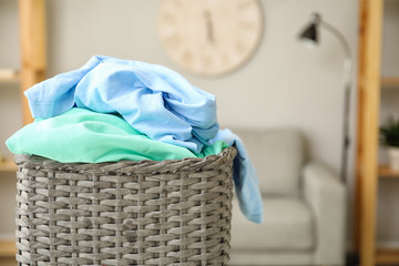 Basket with laundry in room