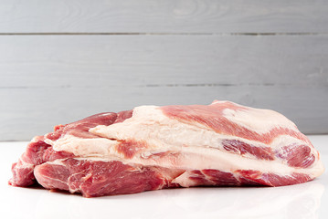Fresh raw pork neck meat isolated on white background. Pork belly on a white background. Raw pork neck boneless, close-up, isolated.
