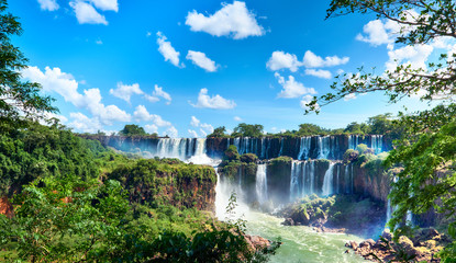 Iguazu waterfalls in Argentina, view from Devil's Mouth, close-up on powerful water streams creating mist over Iguazu river. Sub-tropical rain forest in Iguasu river valley..