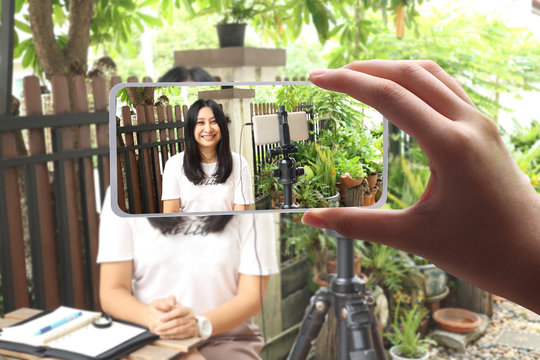 woman working from home , Behind the cellphone shooting video,movie,vlog digital. beautiful asian woman recording video photo,cinema broadcast television,show production maker.