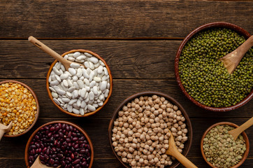 bowl with beans and legumes on old wooden background