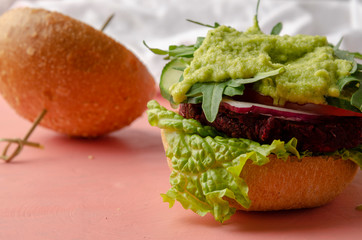 Veggie beet and lentil burgers with vegetables and avocado sauce. Healthy food concept.