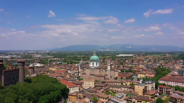 Flying over the Parish of Santa Maria Assunta, Montichiari, Italy. Blue sky. Aerial view