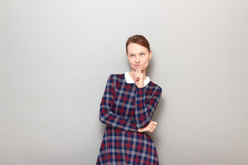 Portrait of thoughtful focused girl trying to make right choice