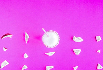 cocktail with coconut on purple background top view pattern