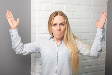 Serious young girl without a mouth on a gray-white background