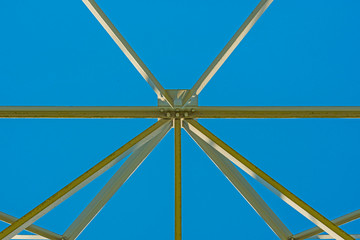 The esthetic side of the construction of a transmission tower in a blue sky in sunlight in spring