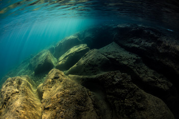 Sunlight and shadows mix underwater in the volcanic seafloor of Flores, Indonesia.