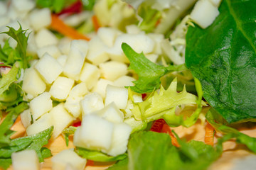 Leafy salad, sliced vegetables and pita sauce are the basis for homemade Shawarma. Close up.