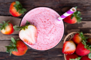 Strawberry  smoothies juice beverage healthy the taste yummy In glass drink episode morning on wooden background from the top view.