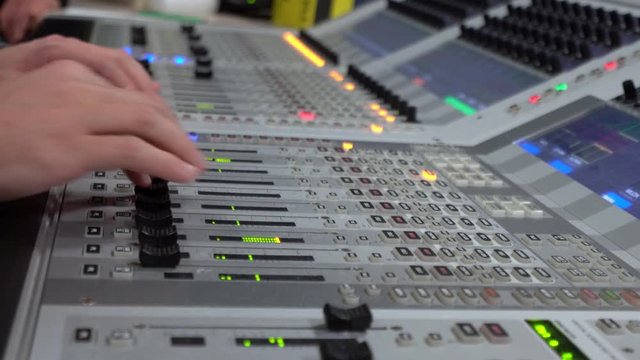 Sound Engineer Moving Sliders In Radio Station. Sound Designer Used Digital Audio Mixer In Production Studio. Soundboard Pads On TV Station. Engineer Press Key Buttons On Control Desk Recording Studio