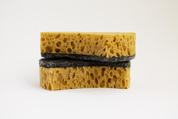 two dish washing sponges yellow clean on a white background lie on top of each other