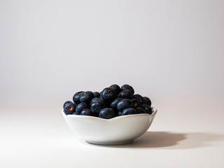 bowl of fresh blueberries on white background