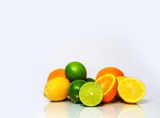 sliced limes lemons and oranges on white background