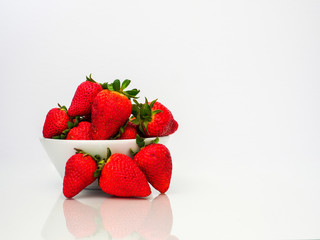 bowl of fresh strawberries on white background