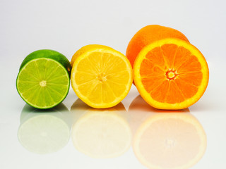 sliced limes lemons and oranges on white background
