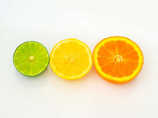 sliced limes lemons and oranges on white background
