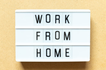 Lightbox with word work from home on wood background