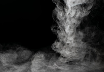 White puffs of smoke on a black background float mixing in bizarre chaotic patterns of thin threads