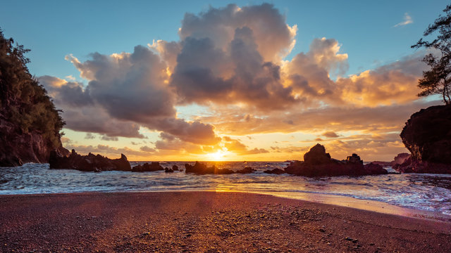 Sunrise on Kaihalulu Beach (Red Sand Beach) in Maui, Hawaii.