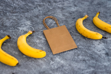 home delivery of groceries, bananas with grocery shopping bag among them