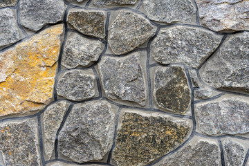 The wall is built of large gray stone bound with cement