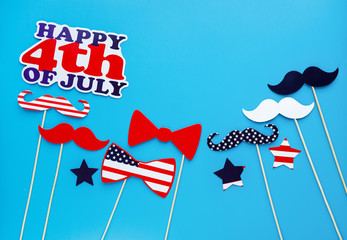 Photo booth for 4th of July. Moustaches, lips, glasses, hat on sticks on blue background. American...